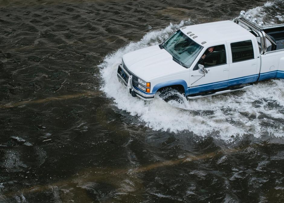 pickup truck driving through floodwater